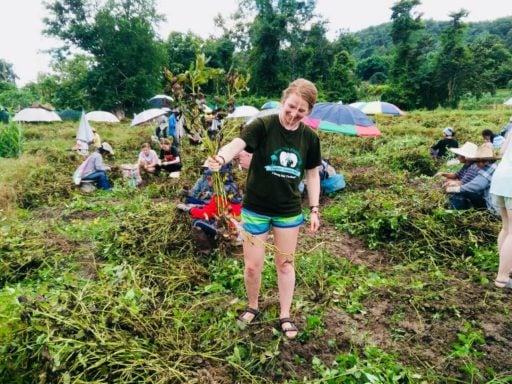 Loop Abroad student pose while uprooting a plant.