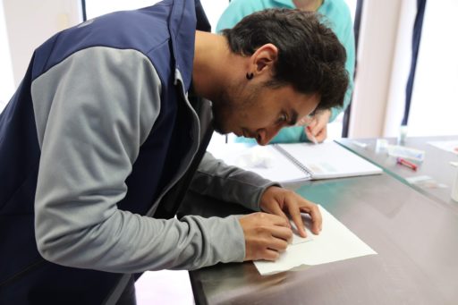 Young man writing on paper