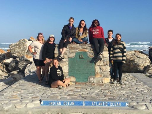 Group of students take a pose on a landmark of Indian ocean and Atlantic ocean