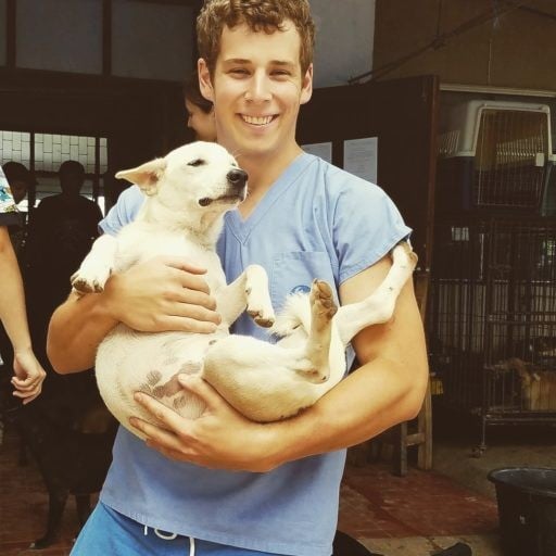 Young pre vet student cuddling a rescue dog.