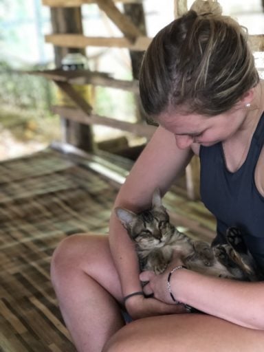 Young lady cuddle cat during her High School Veterinary Internships.