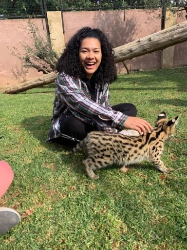 Smiling woman holding small wildcat