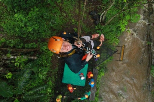 Smiling woman hanging on a rope