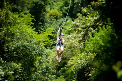 Young man hanging on a zip line